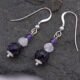 Amethyst, Rainbow Moonstone and Purple Banded Agate Stack Drop Sterling Silver Earrings shown from above on dark grey stone