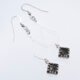 Tourmalinated Quartz Dangle Earrings showing earrings in flat white surface viewed from above