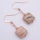 Zebra Jasper Rose Gold Filled Earrings showing other side of Zebra Jasper stones viewed from above on flat white surface