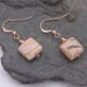 Zebra Jasper Rose Gold Filled Earrings showing other side of the Zebra Jasper stones, shown viewed from above on dark grey stone