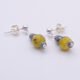 Yellow Turquoise and Hematite Sterling Silver dangles suspended from sterling silver stud ear posts with scroll backs, lying flat on white surface with focus on Yellow Turquoise