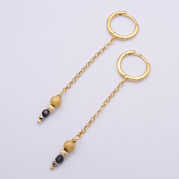 Black Spinel, Pyrite and Gold Vermeil Hinged Earhoop Dangles Black Spinel, Pyrite and Gold Vermeil Hinged Earhoop Dangles shown viewed from above, laid flat on a white surface
