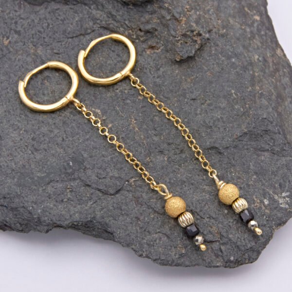 Black Spinel, Pyrite and Gold Vermeil Hinged Earhoop Dangles shown laid flat on dark grey stone