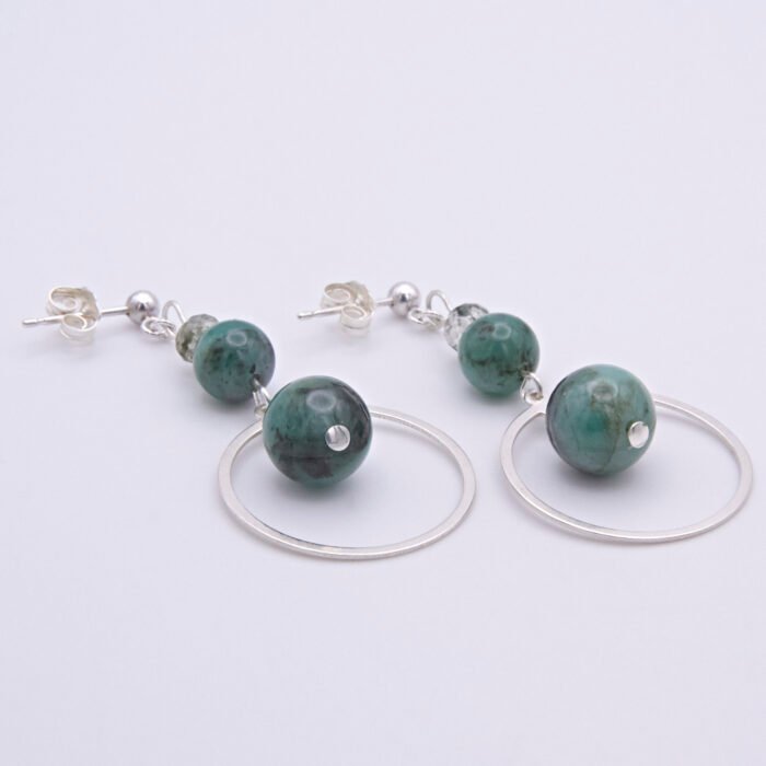 Emerald and Moss Quartz Sterling Silver Hoop Dangle Earrings shown on flat white surface with focus on large emerald beads