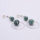 Emerald and Moss Quartz Sterling Silver Hoop Dangle Earrings shown on flat white surface with focus on large emerald beads