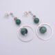 Emerald and Moss Quartz Sterling Silver Hoop Dangle Earrings shown from above on a plain white surface