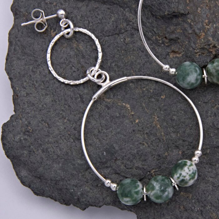 Green Spot Jasper Two-Hoop Sterling Silver Earrings close up of earring on dark grey stone