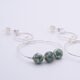 Green Spot Jasper Two-Hoop Sterling Silver Earrings close up of beads, shown on plain white surface