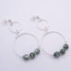 Green Spot Jasper Two-Hoop Sterling Silver Earrings shown from above on flat white surface