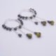 Yellow Turquoise and Hematite Wire-wrapped Hinged Hoop Dangle Sterling Silver Earrings shown on flat white surface, viewed from the side