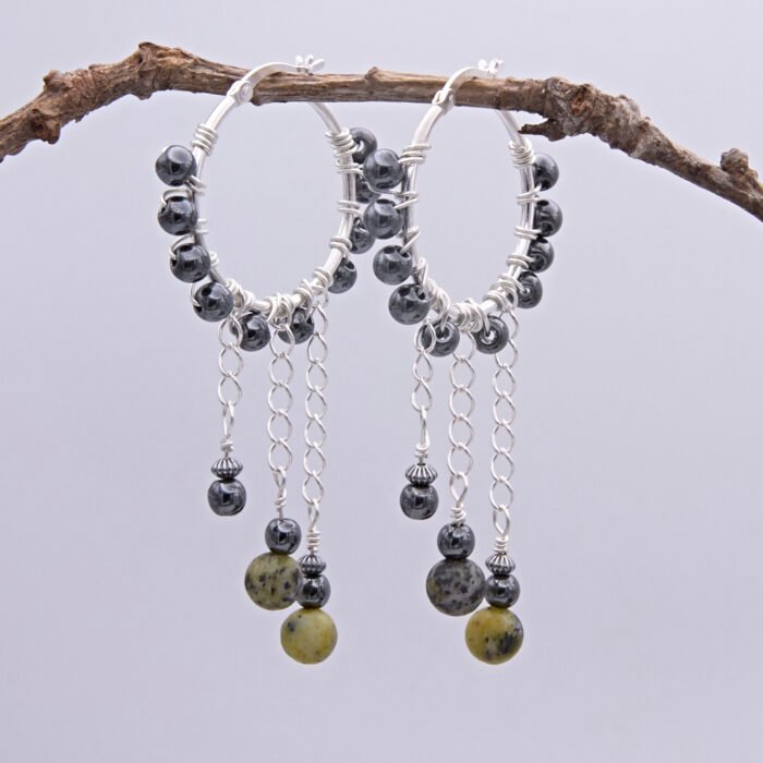 Yellow Turquoise and Hematite Wire-wrapped Hinged Hoop Dangle Sterling Silver Earrings shown hanging from twig