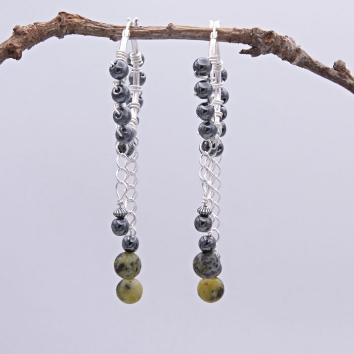Yellow Turquoise and Hematite Wire-wrapped Hinged Hoop Dangle Sterling Silver Earrings shown hanging from twig, side profile