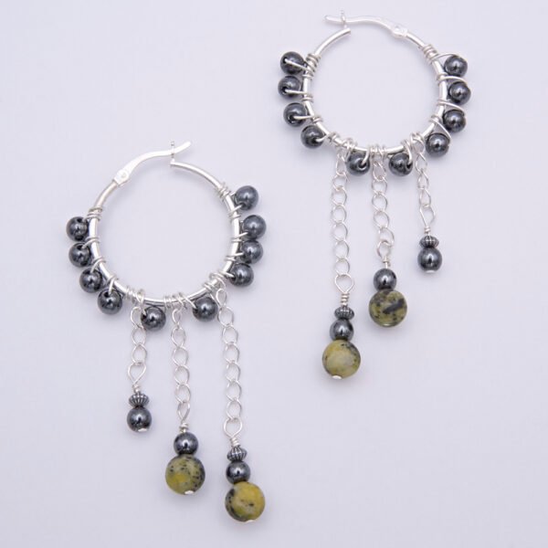 Yellow Turquoise and Hematite Wire-wrapped Sterling Silver Hinged Hoop Dangle Earrings shown from above on plain white surface
