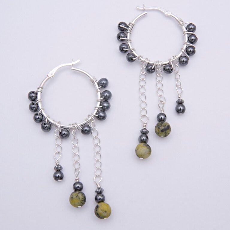 Yellow Turquoise and Hematite Wire-wrapped Sterling Silver Hinged Hoop Dangle Earrings shown from above on plain white surface