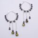 Yellow Turquoise and Hematite Wire-wrapped Sterling Silver Hinged Hoop Dangle Earrings shown from above on plain white surface