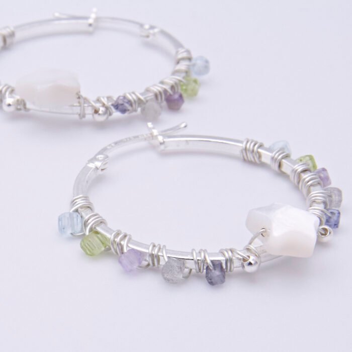 Mother of Pearl Star and mixed gemstone wire wrapped hinged hoop Sterling Silver Earrings Mother of Pearl Star and mixed gemstone wire wrapped onto hinged hoop sterling silver earrings shown lying flat on a plain white surface