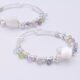 Mother of Pearl Star and mixed gemstone wire wrapped hinged hoop Sterling Silver Earrings Mother of Pearl Star and mixed gemstone wire wrapped onto hinged hoop sterling silver earrings shown lying flat on a plain white surface