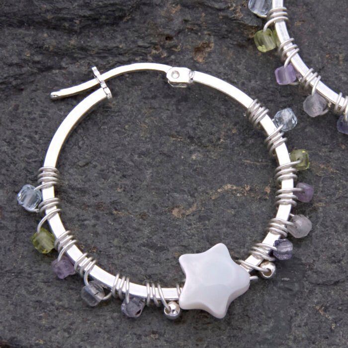 Mother of Pearl Star and mixed gemstone wire wrapped hinged hoop Sterling Silver Earrings Mother of Pearl Star and mixed gemstone wire wrapped hinged hoop Sterling Silver Earrings second single earring laid on grey stone