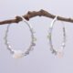 Mother of Pearl Star and mixed gemstone wire wrapped hinged hoop Sterling Silver Earrings Mother of Pearl Star and mixed gemstone wire wrapped hinged hoop Sterling Silver Earrings shown spaced apart hanging from twig