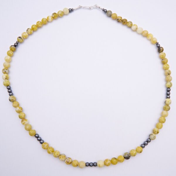 Yellow Turquoise and Hematite Gemstone Bead Necklace with Hook and Eye Clasp, shown from above on flat white surface