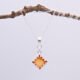 Carnelian Square Cabochon Sterling Silver Pendant Necklace shown hanging from twig