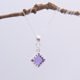Amethyst square cabochon set in Sterling Silver diamond shaped decorative bezel and suspended via decorative bail from a Sterling Silver chain, pictured hanging from twig