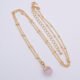 Rose Quartz Cabochon 24k gold plated silver pendant on gold plated satellite chain Rose Quartz Cabochon 24k gold plated silver pendant on gold plated satellite chain shown from above on flat white surface