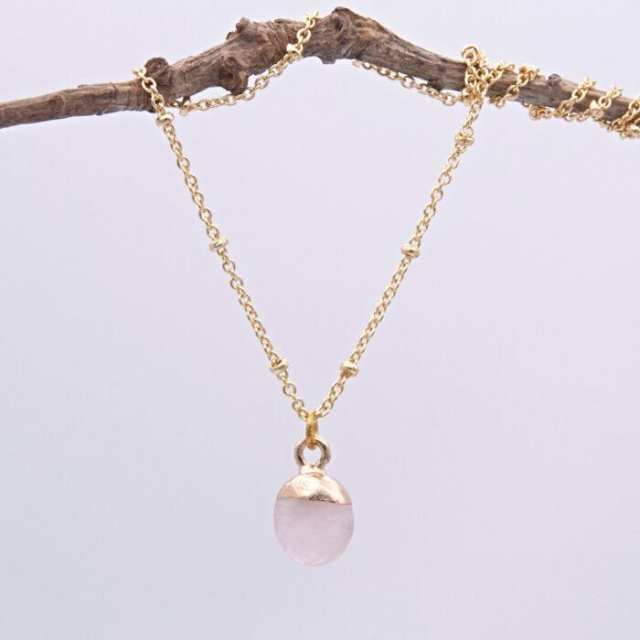 Rose Quartz Cabochon 24k gold plated silver pendant on gold plated satellite chain Rose Quartz Cabochon 24k gold plated silver pendant on gold plated satellite chain shown hanging from twig