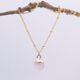Rose Quartz Cabochon 24k gold plated silver pendant on gold plated satellite chain Rose Quartz Cabochon 24k gold plated silver pendant on gold plated satellite chain shown hanging from twig