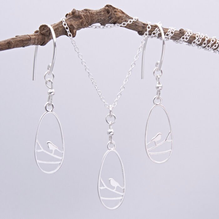 Sterling Silver Robin on Branch Pendant Necklace and Earrings set Sterling Silver Robin on Branch Pendant Necklace and Earrings set shown hanging from twig