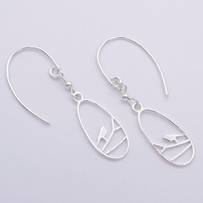 Sterling Silver Robin on Branch Pendant Necklace and Earrings set Sterling Silver Robin on Branch Pendant Necklace and Earrings set Earrings shown laid flat on white surface
