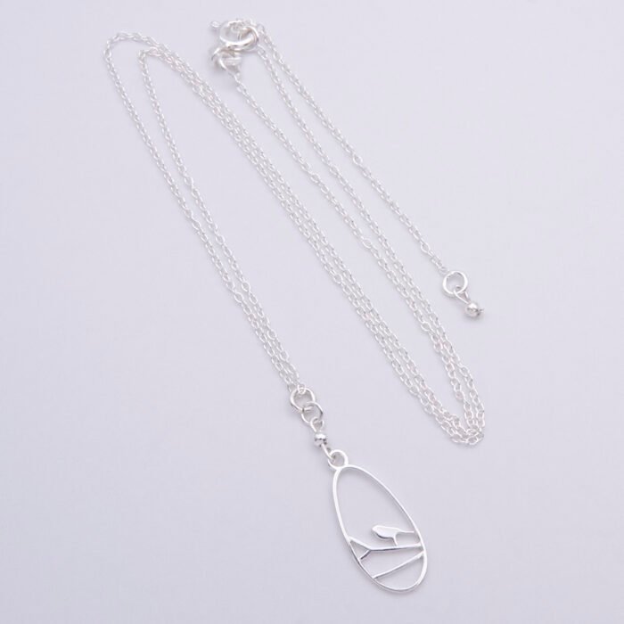 Sterling Silver Robin on Branch Pendant Necklace and Earrings set Sterling Silver Robin on Branch Pendant Necklace and Earrings set Necklace shown laid flat on white surface