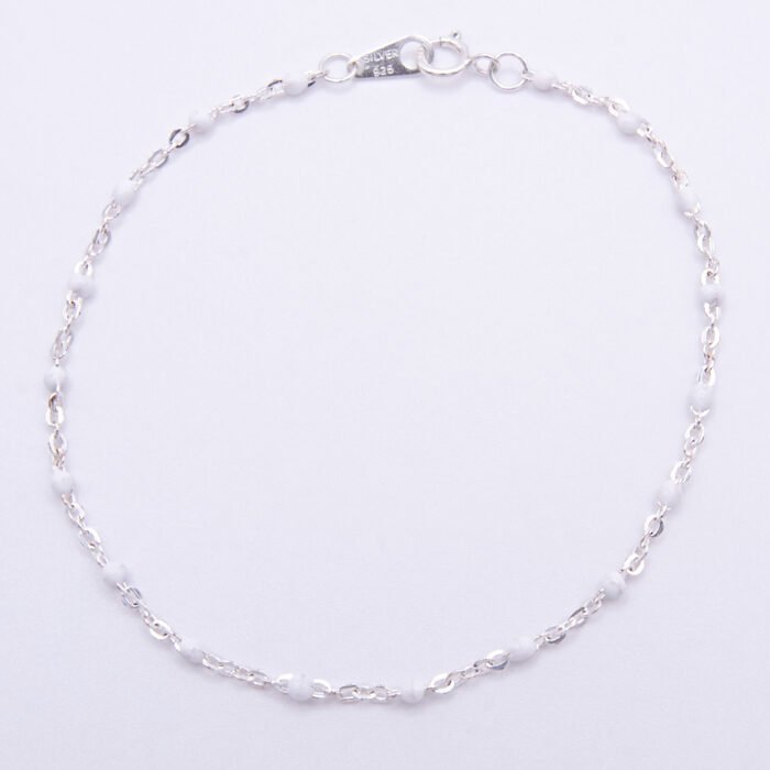 White Enamel Bead Sterling Silver Bracelet shown viewed from above on plain white background