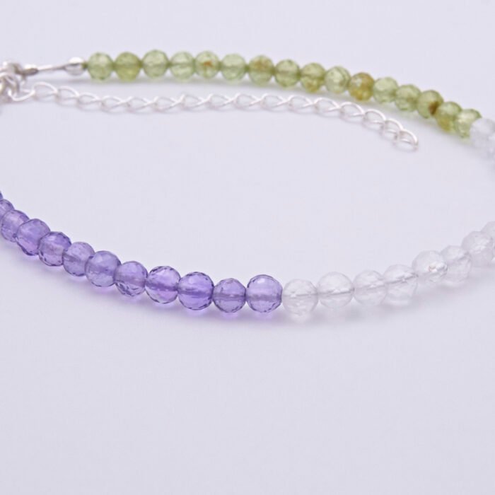 Genderqueer Flag Colours Amethyst, Crystal Quartz and Peridot Gemstone Bracelet with Sterling Silver clasp and extender chain, shown close up from the side, on a plain white background