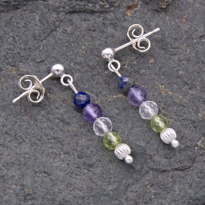 Lapis, Amethyst, Crystal Quartz and Peridot Gemstone Dangle Sterling Silver Stud Earrings shown laid flat on dark grey stone