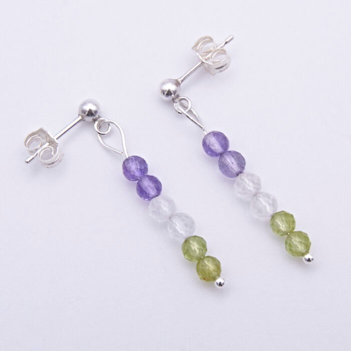 Sterling Silver Stud Earrings with Mixed Gemstone Dangles in Amethyst, Crystal Quartz and Peridot shown laid flat on white surface