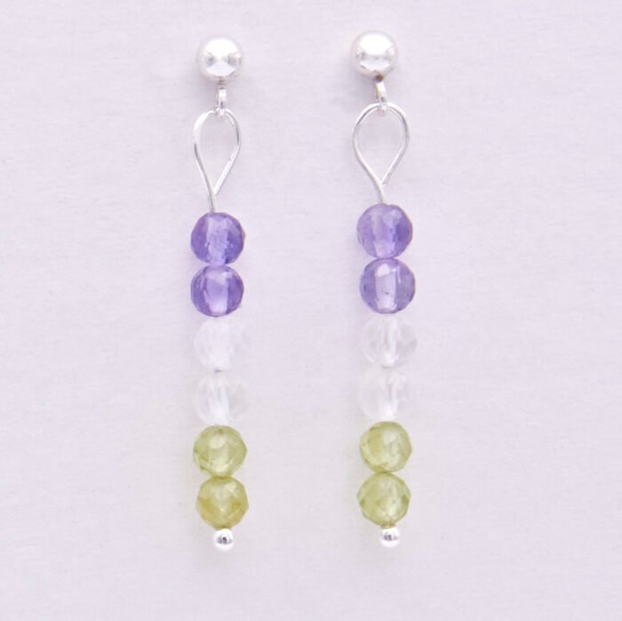 Sterling Silver Stud Earrings with Mixed Gemstone Dangles in Amethyst, Crystal Quartz and Peridot representing the colours of the Genderqueer Flag, shown hanging from white display card