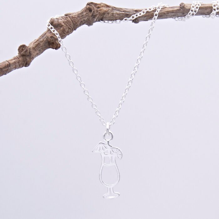 Sterling Silver Cocktail Charm Pendant Necklace shown hanging from twig