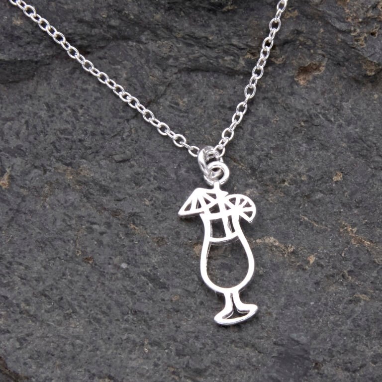 Sterling Silver Cocktail Charm suspended from a Sterling Silver chain, image shows close-up of cocktail and small portion of chain, laid flat on dark grey stone