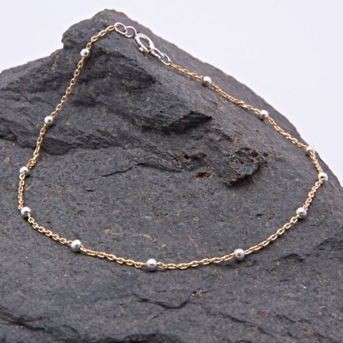 Gold Filled and Sterling Silver Chain Bracelet Gold Filled and Sterling Silver Chain Bracelet shown on dark grey stone