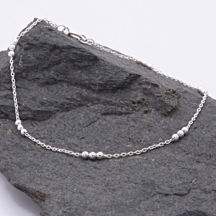 Sterling Silver Three Bead Chain Bracelet Sterling Silver Three Bead Chain Bracelet shown on dark grey stone