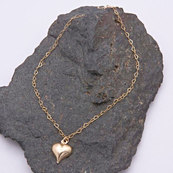 Gold Filled Heart Link Bracelet with Gold Heart Charm, shown laid flat on dark grey stone