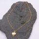 Gold Filled Heart Link Bracelet with Gold Heart Charm, shown laid flat on dark grey stone