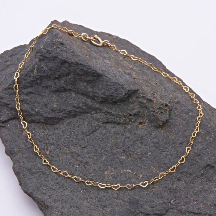Tiny Gold Filled Heart Link Chain Bracelet shown displayed on dark grey stone