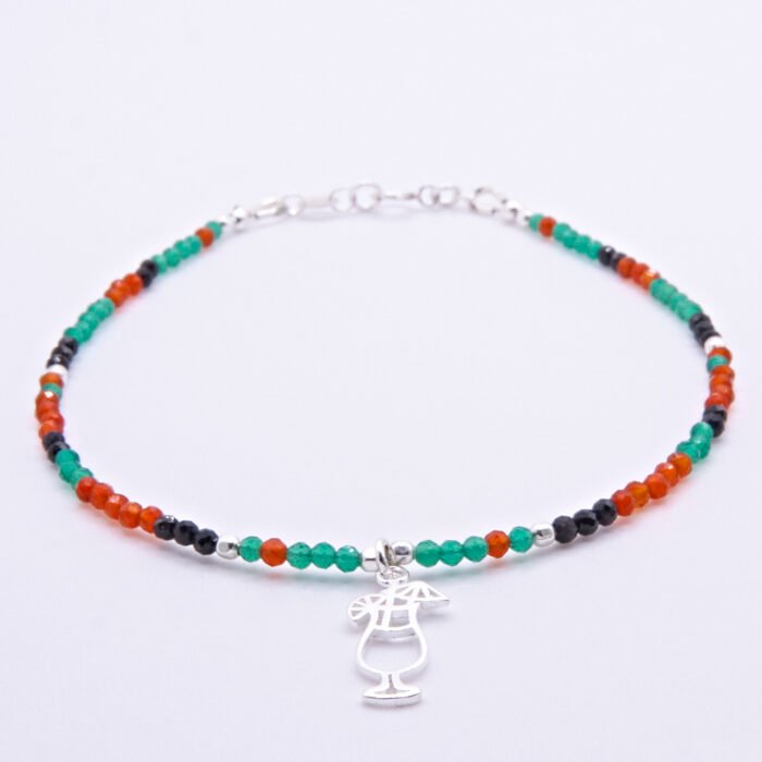 Green Onyx, Carnelian and Sapphire Sterling Silver Bracelet with Sterling Silver Cocktail Charm in the centre, image shows bracelet laid flat on white surface with charm front and centre