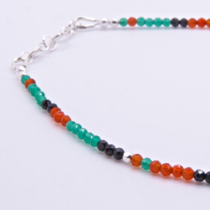 Green Onyx, Carnelian and Sapphire Sterling Silver Bracelet with Sterling Silver Cocktail Charm in the centre, image shows close-up of some of the beading and the clasp, on a plain white background