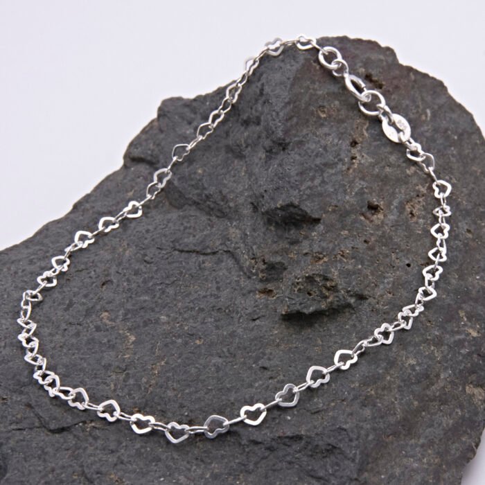 Sterling Silver Tiny Heart Link Chain Bracelet Sterling Silver Tiny Heart Link Chain Bracelet displayed on dark grey stone