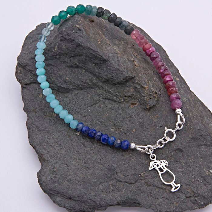 Mixed Gemstone Bracelet with Sterling Silver Cocktail Charm shown on dark slate