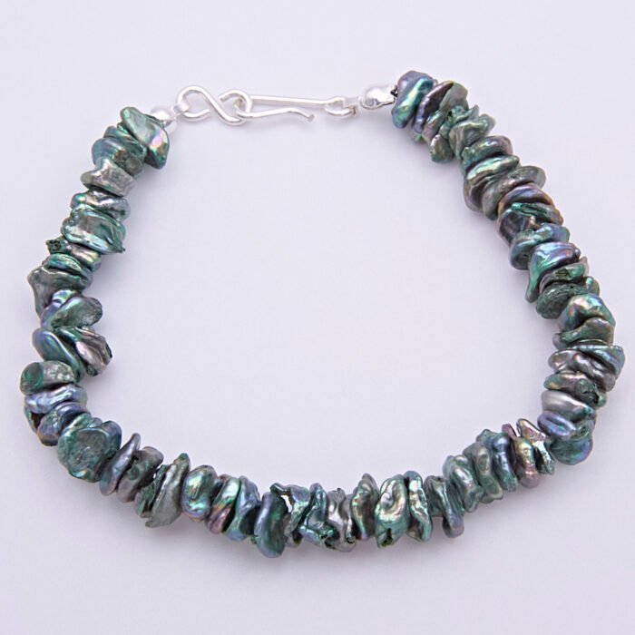 Green Keishi Cornflake Freshwater Pearl and Sterling Silver Bracelet, shown viewed from above on plain white surface, with clasp at the top of the image