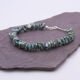 Green Keishi Cornflake Freshwater Pearl and Sterling Silver Bracelet, shown viewed from the side on dark slate